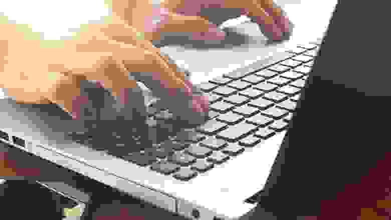 Close Up of a Person Typing on the Notebook Computer