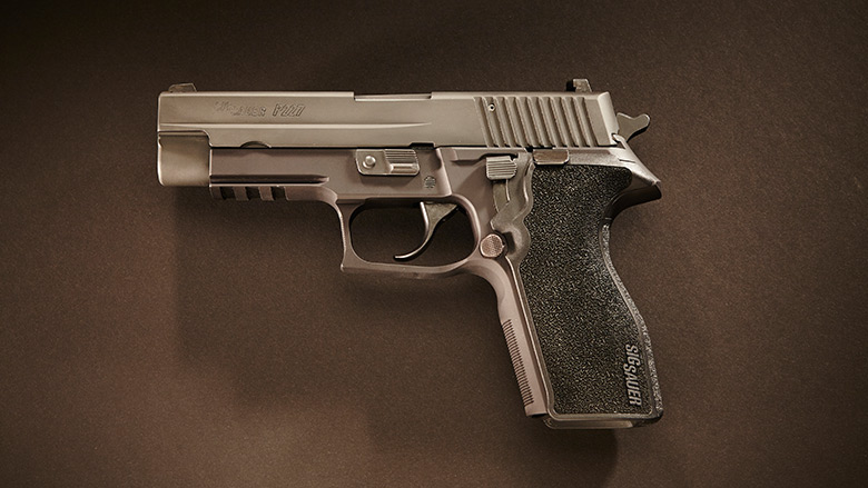 Pistol Laying on a Brown Background